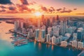 A panoramic aerial view of the Miami skyline at sunset, showcasing the city\'s iconic pastel-colored buildings