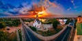 Panoramic aerial view of old church near river and bridge in small european city Royalty Free Stock Photo