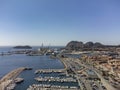 Panoramic aerial view on historical coastal Provencal city La Ciotat with large sailboat harbour and yacht shipyard, summer