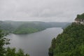 Panoramic aerial view over the top of a summer landscape of a green hills, a large river, and a forest belt at sunset Royalty Free Stock Photo