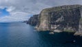 Panoramic aerial view from Sandoy island cliffs and rock stacks under the clouds Royalty Free Stock Photo