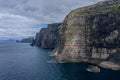 Panoramic aerial view from Sandoy island cliffs and rock stacks under the clouds Royalty Free Stock Photo