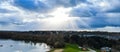 Panoramic Aerial view of sun's rays pierce the clouds on beautiful Lake from a drone Royalty Free Stock Photo