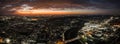 Panoramic aerial view of sunset over lights from city grid Royalty Free Stock Photo