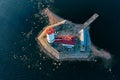 Panoramic aerial view of the Tolbukhin lighthouse. Artificial rocky island in the Gulf of Finland. The oldest Russian lighthouse.