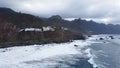 Panoramic aerial view of wild coastline with big waves on the north coast of the island Tenerife, Spain. Little village in the Royalty Free Stock Photo