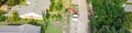 Panoramic aerial view working truck with a lift cutting down tree at suburban house near Dallas, Texas, USA Royalty Free Stock Photo