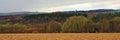 Panoramic Ardennes landscape,with empty winter farmland and forests and hills on a rainy day with dark clouds Royalty Free Stock Photo