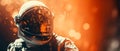 Astrounat wearing space suit closeup. Orange background.