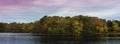 Panoramic autumn lake landscape with colorful foliage and reflections on the water surface Royalty Free Stock Photo