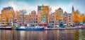 Panoramic autumn view of Amsterdam city. Famous Dutch channels and great cityscape. Splendid morning scene of Netherlands, Europe.