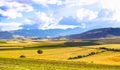 Panoramic background of beautiful yellow-green fields with blue sky and clouds - sunny day in Kahramanmaras, Turkey Royalty Free Stock Photo