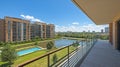 Panoramic balcony view of modern apartment complex overlooking a tranquil lake Royalty Free Stock Photo