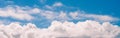 Panoramic banner blue sky white puffy clouds masthead for web design Royalty Free Stock Photo