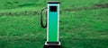 Panoramic banner of EV, electric car charger station on background of green grass.