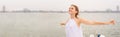 Panoramic banner image of Portrait of a beautiful woman in white dress with free carefree happy girl looking at ocean with open Royalty Free Stock Photo