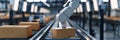 Panoramic banner of robot arm in industrial warehouse packing station shipping cartboard box Royalty Free Stock Photo