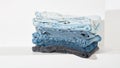 panoramic banner. stack of folded blue, blue and gray jeans close up with copy space Royalty Free Stock Photo