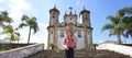 Panoramic banner view of beautiful tourist woman visiting the baroque colonial city of Ouro Preto, old capital of the state of Royalty Free Stock Photo