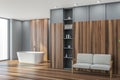 Panoramic bathroom corner: wooden coatings, white bathtub, grey walls Royalty Free Stock Photo