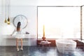 Panoramic bathroom, white tub and sink, woman Royalty Free Stock Photo