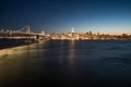 Panoramic beautiful scenic view of the Oakland Bay Bridge and the San Francisco city in the evening, California, USA Royalty Free Stock Photo