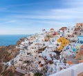 Panoramic beautiful view of Oia town on Santorini island, Cyclades, Greece. Traditional famous white houses, windmills and Royalty Free Stock Photo