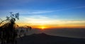 Panoramic beautiful view from top of the volcano Agung at dawn. View of the rising sun and Rinjani mount on the horizon from a