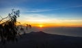 Panoramic beautiful view from top of the volcano Agung at dawn. View of the rising sun and Rinjani mount on the horizon from a