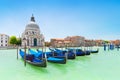 Panoramic beautiful  view of traditional venetian gondolas moored in water of Grand Canal in front of Basilica di Santa Maria Royalty Free Stock Photo