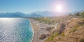 Panoramic bird view over Antalya modern part of the city, Mediterranean seacoast and long pebble beach with tourists and with lens Royalty Free Stock Photo