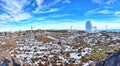 Panoramic of Calar Alto Observatory at the snowy mountain top in Almeria, Andalusia, Spain, 2019. Sky passing through against the