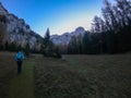 Hochschwab - A woman hiking through the forest in Alps