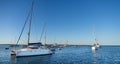 Panoramic of a catamaran anchored on a beach in the Formentera island during sunset. Royalty Free Stock Photo