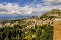 PANORAMIC CITY OF TAORMINA AND MOUNTAINS FROM GREEK THEATER Royalty Free Stock Photo