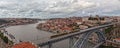 Panoramic of the cityscape of Porto and a train on the Luis I bridge over the Douro river, Portugal