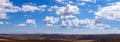 Panoramic clouds over hills Royalty Free Stock Photo