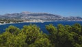 Panoramic coastal view to Atea over mediteranean sea and blurred pines in natural park `Serra Gelada` in Albir, Spain Royalty Free Stock Photo