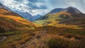 Panoramic colorful landscape with footpath along water streams in valley in autumn colors with view to autumn mountains and rocks Royalty Free Stock Photo