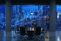 Panoramic conference room in modern office, cityscape of New York skyscrapers at night, Manhattan. Royalty Free Stock Photo