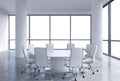 Panoramic conference room in modern office, copy space view from the windows. White chairs and a white round table.