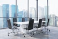 Panoramic conference room in modern office in Singapore. Black chairs and a white table.