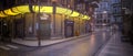 Panoramic 3D illustration of dark moody downtown city street with yellow neon lights
