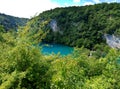 Panoramic distant view on the lake with luminous azure-colored water. Trees and greenery around. Plitvice Lakes, Croatia Royalty Free Stock Photo