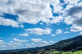 A panoramic and dramatic cloudscape with many clouds on a blue sky over rural mountain hills Royalty Free Stock Photo