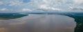 The Amazon River with one ship as scale of the magnitude and the Iquitos city in the background.