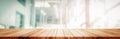 Panoramic empty clean wood counter table top on blur glass window white light background for product morning scene display montage Royalty Free Stock Photo