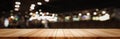 Panoramic empty clean wood counter table top on blur street night cafe background use for pub coffee shop montage dark scene,