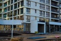 Panoramic entrance to the high-rise building. brown and white home decoration. glass windows on the ground floors. arrangement of