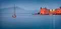 Panoramic evening cityscape of Gaeta town with yacht and lighthouse. Royalty Free Stock Photo